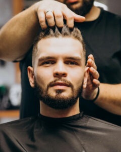 A barber styling a man's hair
